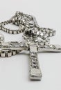 Silver christian cross necklace isolated on white. Cross of silver on a chain. Royalty Free Stock Photo