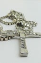Silver christian cross necklace isolated on white. Cross of silver on a chain. Royalty Free Stock Photo