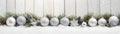 Silver Christmas balls, stars and trees in a row with spruce branches. Royalty Free Stock Photo