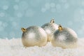 Silver Christmas balls in white snow on a blue background with bokeh lights. happy new year card Royalty Free Stock Photo