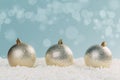 Silver Christmas balls in white snow on a blue background with bokeh lights. happy new year card Royalty Free Stock Photo
