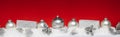 Silver Christmas balls with xmas gift boxes in a row on snow.Red background Royalty Free Stock Photo