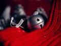 Silver Christmas bauble bell with red wool background Royalty Free Stock Photo