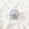 Silver Christmas bauble on snow white fluffy fur. Christmas or winter holiday concept. Texture background Royalty Free Stock Photo