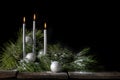 Silver Christmas Candles with Evergreen and Snow Royalty Free Stock Photo