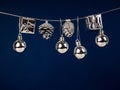 Silver Christmas New Year baubles for Christmas tree ornaments, pine, spruce, balls, stars, bells, pine cones on blue Royalty Free Stock Photo