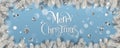 Silver Christmas and New Year Text on blue Xmas background with snowy fir branches, silver ribbon, decoration, sparkles, confetti, Royalty Free Stock Photo