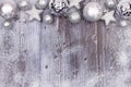 Silver Christmas ornament top border with snow frame on wood