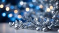 silver christmas tree branches on blurred blue holiday background with lights. Royalty Free Stock Photo