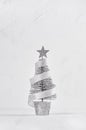 Silver christmas tree, star, tape on white shabby plaster and wood background. Royalty Free Stock Photo