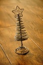 Silver Christmas tree and star on a wooden floor