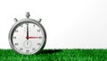 Silver chronometer on green grass