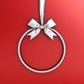 Silver circle frame hanging with silver ribbon and bow for christmas decoration and other events isolated on red Royalty Free Stock Photo
