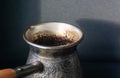 Silver coffee pot on the black background. Close up