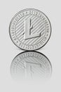 Silver coin Litecoin on white glossy background. Business and technology concept Royalty Free Stock Photo