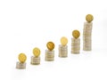 Silver coin stacks of different high with top with gold coin standing on edge. Selected focus. Royalty Free Stock Photo