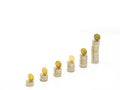 Silver coin stacks of different high with top with gold coin standing on edge. Selected focus Royalty Free Stock Photo