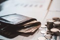 Silver coins and cash placed in piles on desk with light sunset .Instagram style filter photo vintage tone