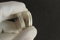 Silver coins in the hand of a numismatist. Grooved coin edges