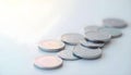 Silver Coins Scattered on White Surface with Soft Light Royalty Free Stock Photo