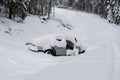 Stolen and ditched car in winter covered with thick layer of snow