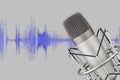 Silver colored condenser microphone on waveform background