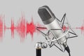 Silver colored condenser microphone on waveform background