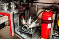 a silver-colored fire hydrant with red valves and other fire equipment lies in fire car. red extinguisher