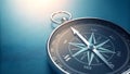 Silver compass with detailed design on blue background surface Royalty Free Stock Photo