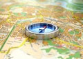 Silver compass on the map. Royalty Free Stock Photo