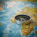 A silver compass rests on a detailed map of Africa. The map highlights countries in Royalty Free Stock Photo
