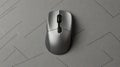 A silver computer mouse on a gray surface with geometric line patterns Royalty Free Stock Photo