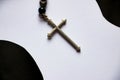 The silver cross on black and white paper background.