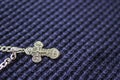 Silver cross on a blue background. Symbol of faith. Christianity Royalty Free Stock Photo