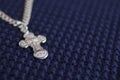 Silver cross on a blue background. Symbol of faith. Christianity Royalty Free Stock Photo