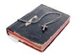 Silver cross on old bible with leather cover