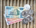 Silver crypto coins Litecoin LTC, paper denominations Belarusian ruble. Metal coins are laid out in a flat background, close-up vi