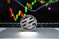 Silver cryptocurrency coin - Litecoin coin is placed on a laptop with a graph background in the computer screen Royalty Free Stock Photo