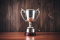 silver cup trophy on a polished wooden background Royalty Free Stock Photo