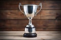 silver cup trophy on a polished wooden background Royalty Free Stock Photo