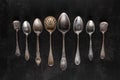 Silver cutlery on black background.Pile of vintage silverware and empty plates on dark grey background.  Top view point Royalty Free Stock Photo