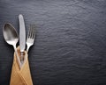 Silver cutlery on a dark grey background. Royalty Free Stock Photo