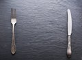 Silver cutlery on grey background. Royalty Free Stock Photo