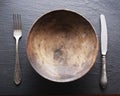 Silver cutlery and old wooden plate. Royalty Free Stock Photo