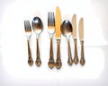 A silver cutlery set arranged elegantly on a silk tablecloth Royalty Free Stock Photo