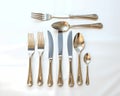A silver cutlery set arranged elegantly on a silk tablecloth Royalty Free Stock Photo