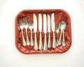 A silver cutlery set displayed in a velvet-lined tray on a table Royalty Free Stock Photo