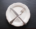 Silver cutlery and vintage plate on a dark background. Royalty Free Stock Photo