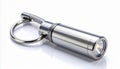 Silver Cylindrical Flashlight with Clip and Keyring on White Surface Royalty Free Stock Photo