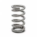 A silver cylindrical metal spring with flat ends, isolated on a white Royalty Free Stock Photo